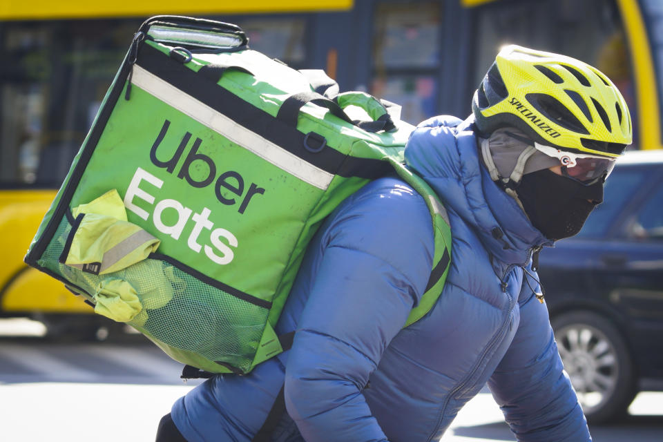 A Uber Eats delivery cyclist is seen wearing a face mask in Warsaw, Poland on March 23, 2020. Polish government spokesman Piotr Muler on Monday announced the administration would not rule out further expanding restrictions to prevent the spread of the coronavirus. The government in the previous week already banned the opening of cinemas, restaurants and bars for at least ten days. People are encouraged to stay at home and gatherings of more than 50 people are prohibited. (Photo by Jaap Arriens/NurPhoto via Getty Images)