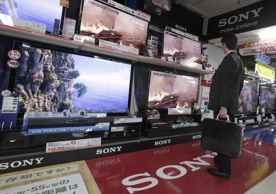 A man looks at Sony's Bravia flat panel TV sets on display at a Tokyo electronics store Thursday, Nov. 1, 2012. Sony Corp. reported Thursday a smaller flow of red ink for the fiscal second quarter on a sales recovery and restructuring efforts and stuck to its full year forecast for a return to profit from its worst loss in company history the previous year. The Japanese electronics and entertainment company recorded a 15.5 billion yen ($193 million yen) loss for the July-September period, much better than the 27 billion yen loss racked up the same period the previous year. (AP Photo/Shizuo Kambayashi)