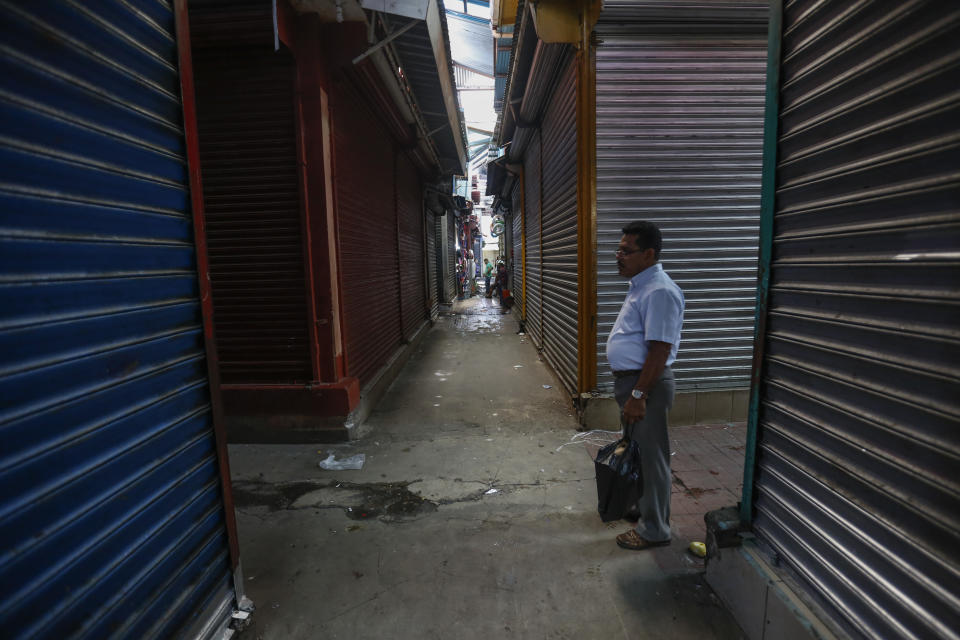 In this Sept 7, 2018 photo, a man walks in the empty and shuttered halls of the Oriental Market during a 24 hour national strike, in Managua, Nicaragua. In June, the country's economic activity was down 12.1 percent compared to a year earlier, according to the central bank. (AP Photo/Alfredo Zuniga)