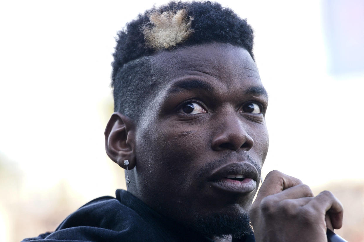 In this photograph taken on December 29, 2019 France national team player Paul Pogba speaks to the spectators prior to a football match between All Star France and Guinea at the Vallee du Cher Stadium in Tours, central France, as part of the "48h for Guinea" charity event. (Photo by GUILLAUME SOUVANT / AFP)