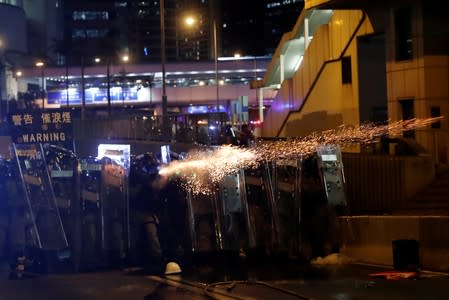 Riot police fire tear gas at demonstrators during a protest against police violence in Hong Kong