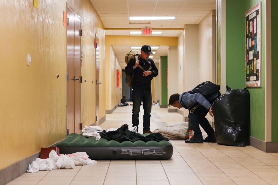 Richard Darmstadt, 55, and Richard Darmstadt, Jr. (right), 25, pack up to leave the shelter at Meadowbrook Elementary School in Gainesville, Fla., on Thursday, Sept. 29, 2022.