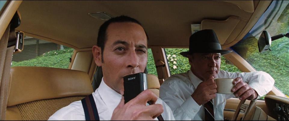 Paul Reubens talking into a recorder