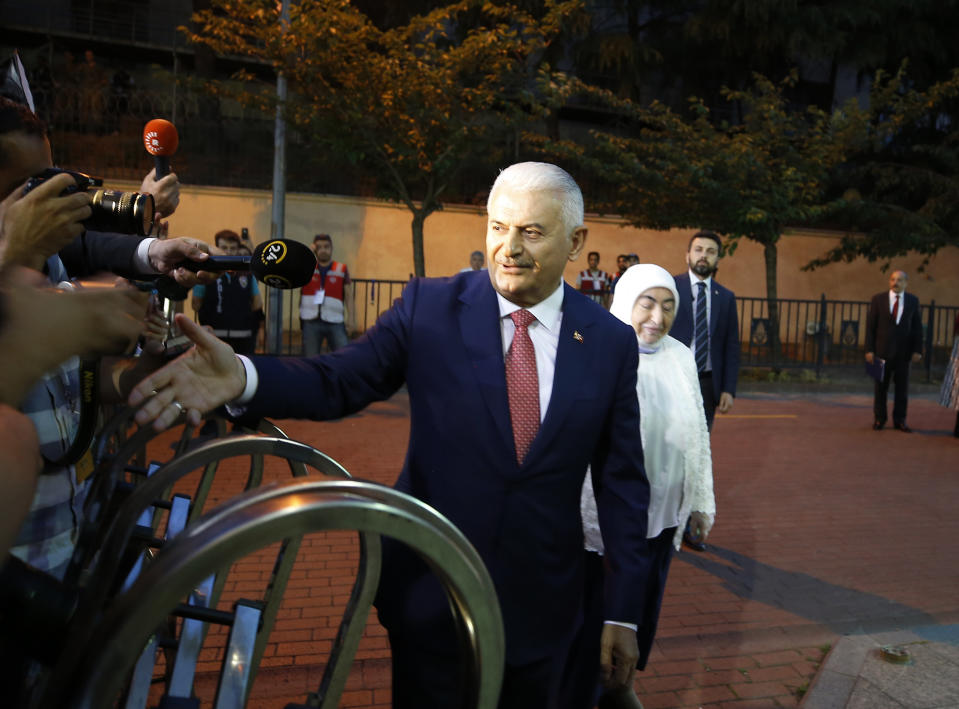 Istanbul's mayoral candidate Binali Yildirim, of Turkey's ruling Justice and Development Party, or AKP, waves as he arrives for a televised debate with Ekrem Imamoglu, candidate of the secular opposition Republican People's Party, or CHP, ahead of June 23 re-run of Istanbul elections, Sunday, June 16, 2019. Televised election debates are uncommon in Turkey. The last one, between AKP leader Recep Tayyip Erdogan and the then-leader of the CHP, took place before a 2002. The AKP has been in power since. (AP Photo/Emrah Gurel)