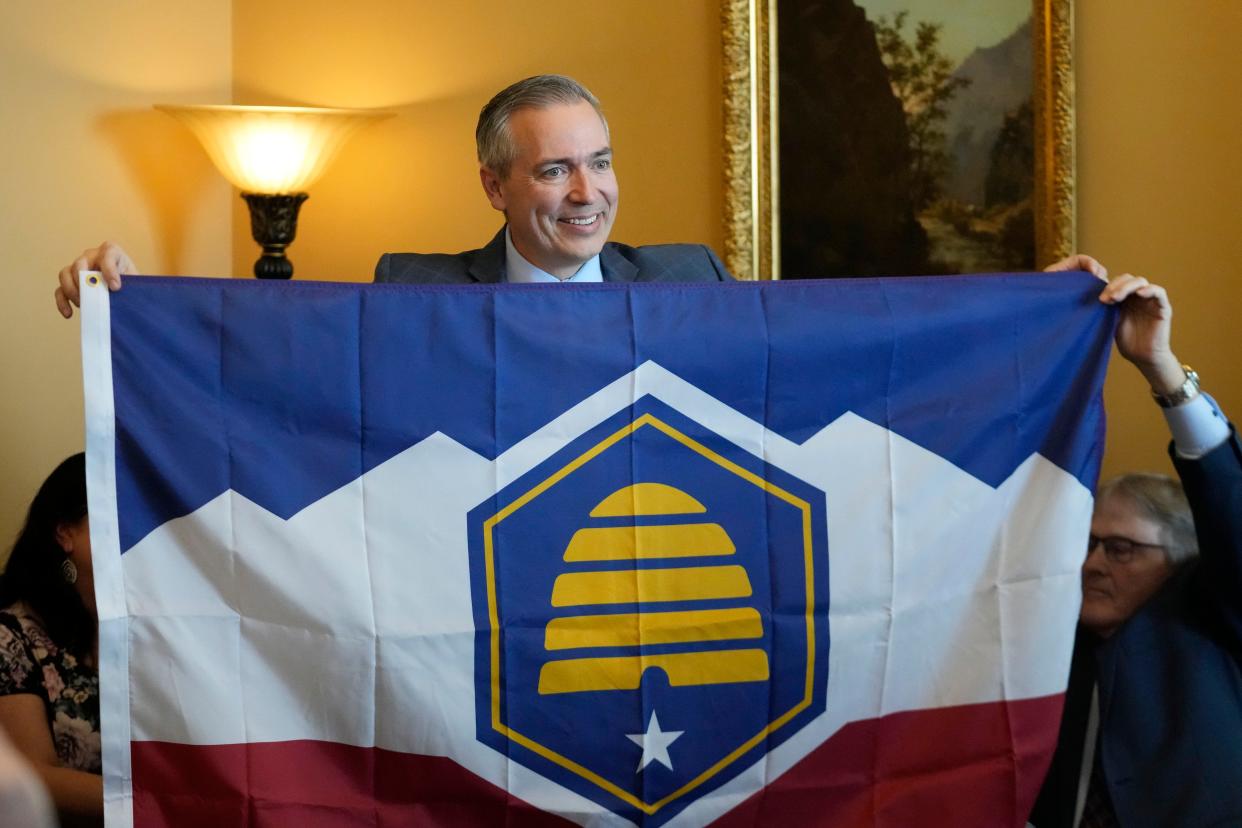 Utah Sen. Dan McCay, R-Riverton, unfurls the state's new flag during a Senate media availability on Thursday, March 2, 2023, in Salt Lake City. Opponents of the new state flag have filed a referendum in an attempt to bypass the Legislature and let voters decide on the design. 