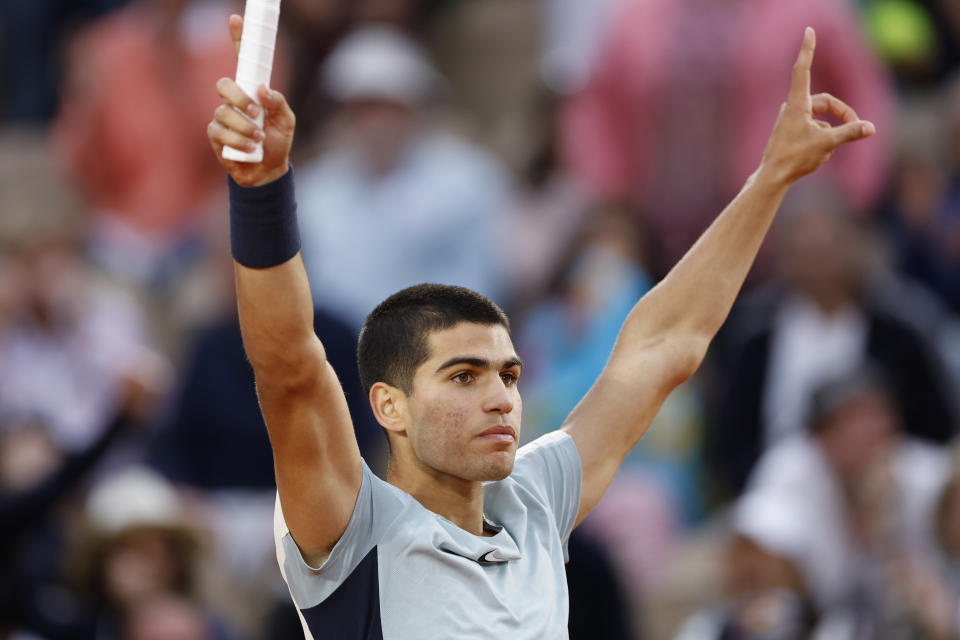 Spain's Carlos Alcaraz celebrates winning against Spain's Albert Ramos-Vinolas in five sets, 6-1, 6-7 (9-7), 5-7, 7-6 (7-2), 6-4, during their second round match at the French Open tennis tournament in Roland Garros stadium in Paris, France, Wednesday, May 25, 2022. (AP Photo/Jean-Francois Badias)