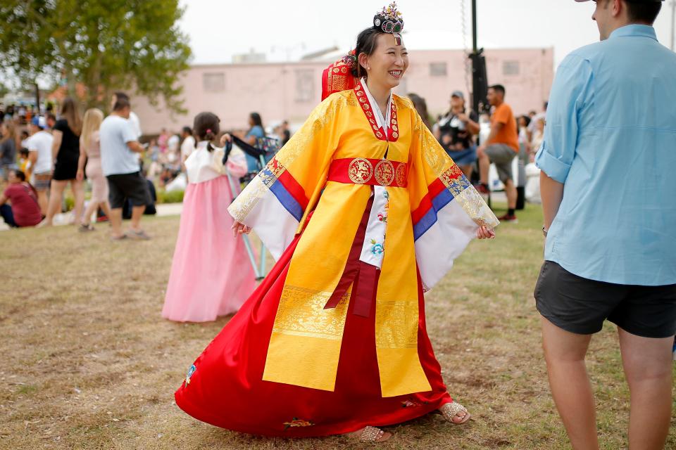 Anna Yoon spins around to cool off before a fashion show during the 2022 Asian Night Market Festival.