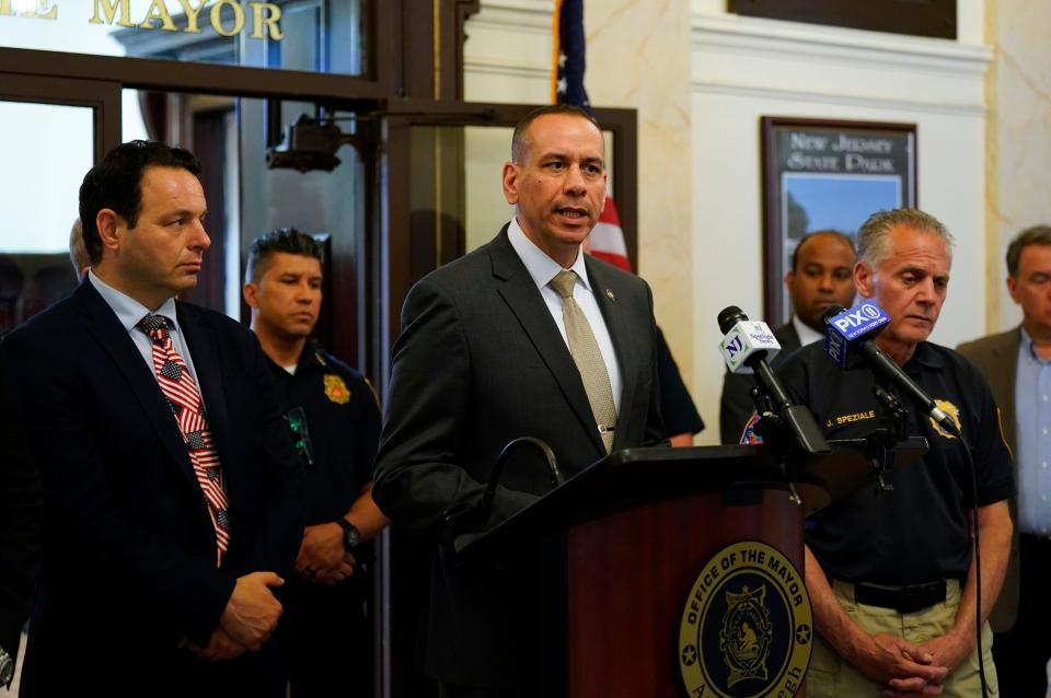 Isa Abbassi, officer in charge of the Paterson Police Department, speaks during a press conference announcing a new anti-crime initiative with Mayor Andre Sayegh (left) at Paterson City Hall on Monday, June 26, 2023.