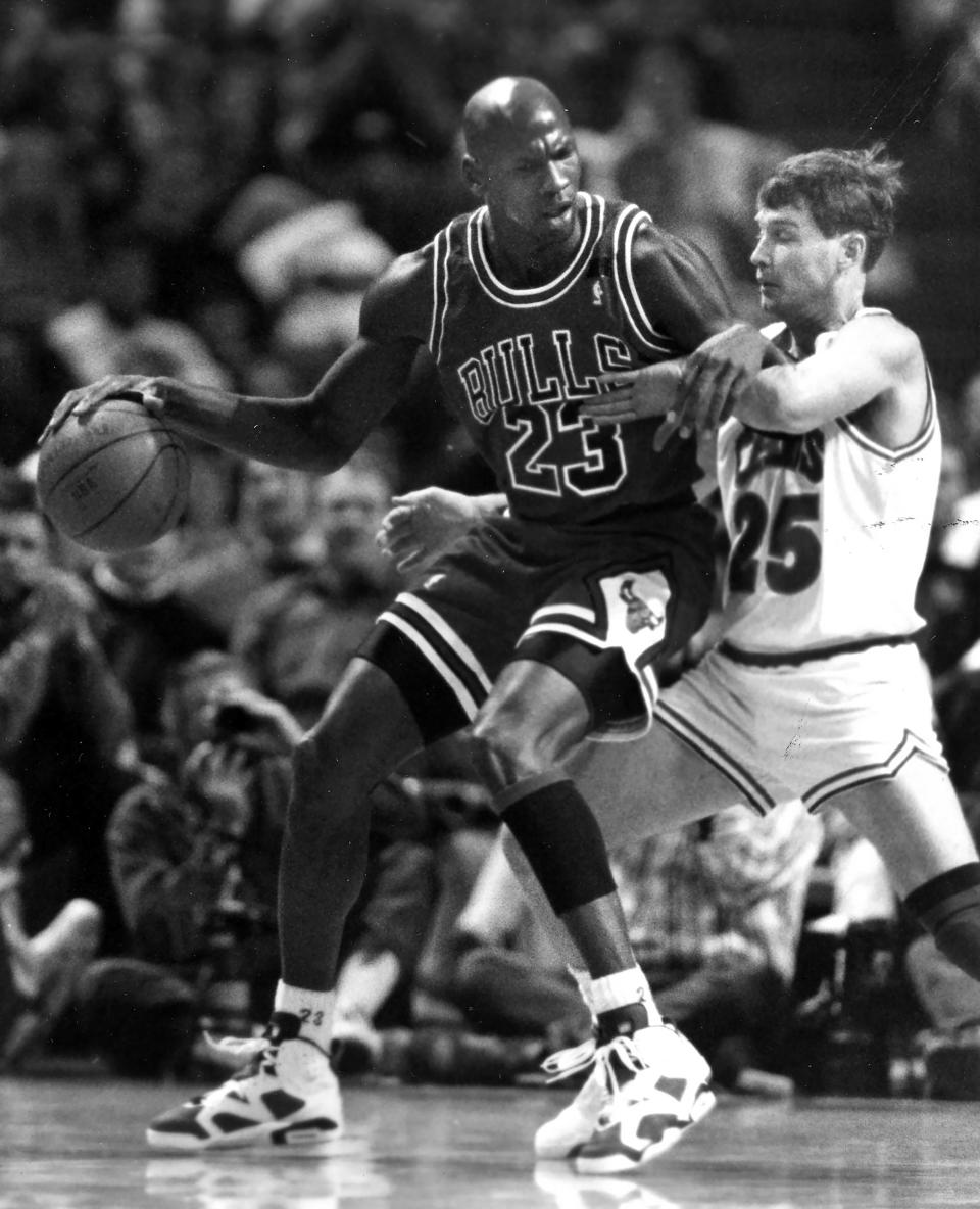 The Chicago Bulls' Michael Jordan, left, keeps the ball and the Cleveland Cavaliers' Mark Price at bay at the Richfield Coliseum on Jan 16, 1992, in Richfield, Ohio.