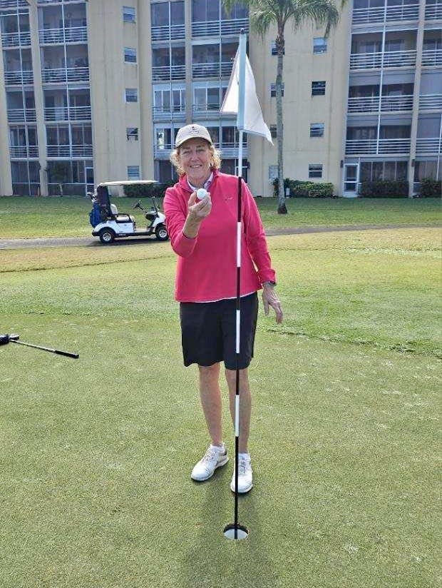 Mary Gale poses with her ball she used to record an ace on the 14th hole. It was her second hole-in-one of her round.