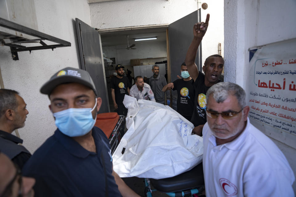 FILE - Members of the World Central Kitchen aid group, transports the body of one of the six foreign aid workers who were killed in an Israeli strike, at a hospital morgue in Rafah, Wednesday, April 3, 2024. World Central Kitchen and a few other aid groups suspended operations in Gaza, after seven aid workers were killed by airstrikes. Yet despite the danger, many of the largest organizations barely slowed down. Hunger has become commonplace in Gaza amid the war with Israel, and U.N. officials warn that famine is increasingly likely in northern Gaza. (AP Photo/Fatima Shbair, File)