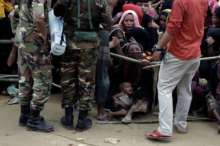 Rohingya refugees queue for aid at Cox's Bazar, Bangladesh, September 26, 2017. REUTERS/Cathal McNaughton