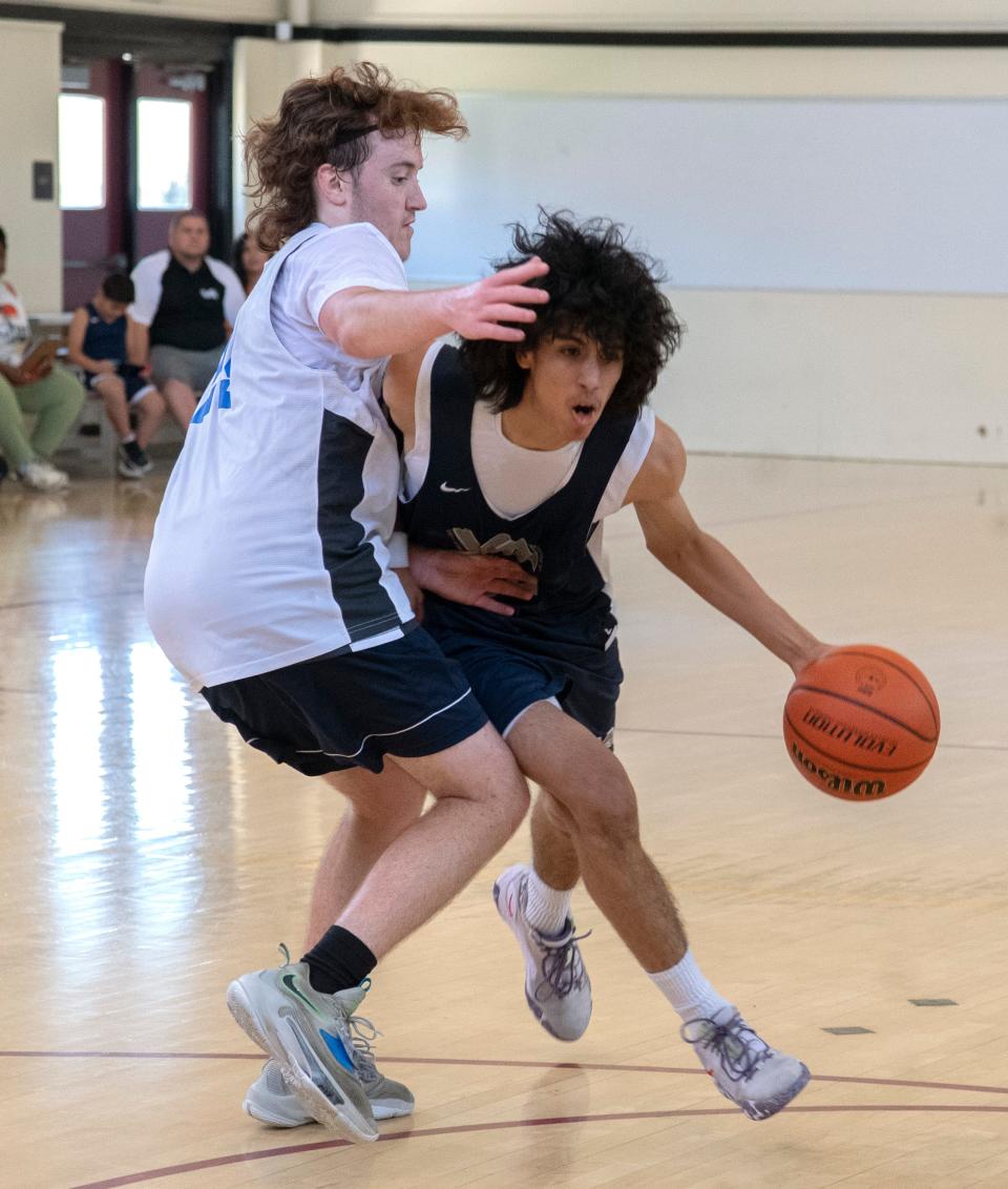 Venture Academy's Marcos Rosales, right, drive on Sierra's Tim Sarginson during a game of the Modesto Christian basketball tournament at Edison High School in Stockton on Friday, June 9, 2023.