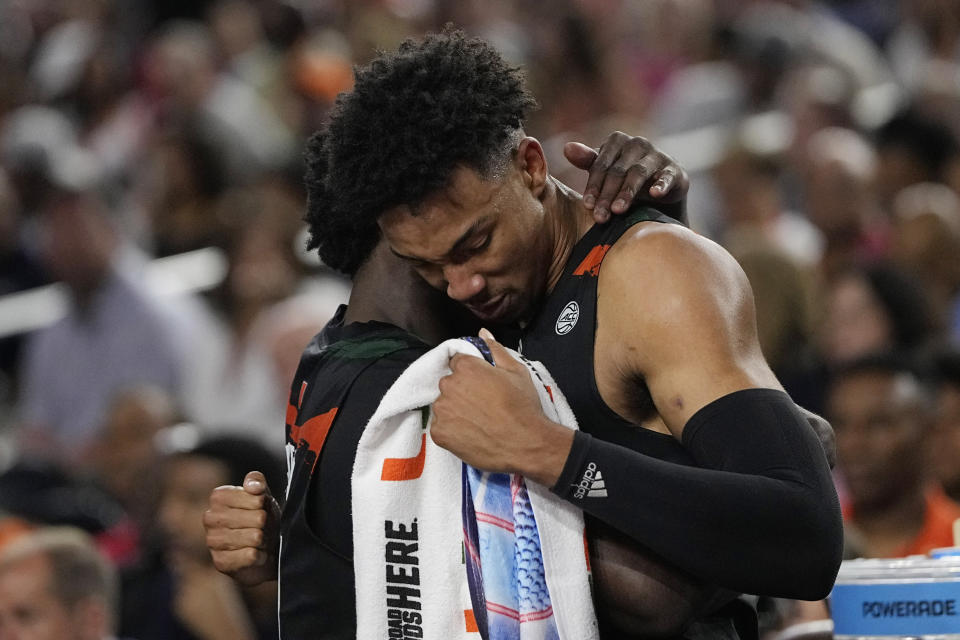 Miami guard Bensley Joseph and guard Jordan Miller hug after their loss against Connecticut in a Final Four college basketball game in the NCAA Tournament on Saturday, April 1, 2023, in Houston. (AP Photo/David J. Phillip)