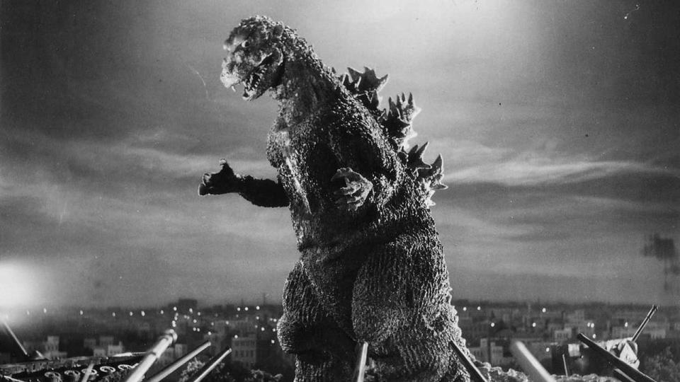 Still from the movie Gojira/Godzilla (1954). It is a black and white image of a giant lizard creature.