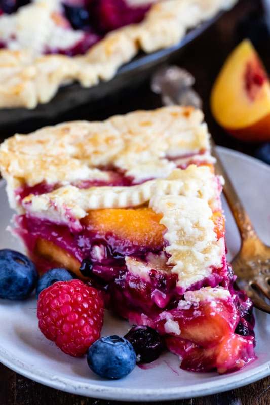 <p>Crazy For Crust</p><p>This beautiful pie is overflowing will summer fruit.</p><p><strong>Get the recipe: <a href="https://www.crazyforcrust.com/raspberry-peach-blueberry-pie/" rel="nofollow noopener" target="_blank" data-ylk="slk:Raspberry Peach Blueberry Pie;elm:context_link;itc:0;sec:content-canvas" class="link ">Raspberry Peach Blueberry Pie</a></strong></p>