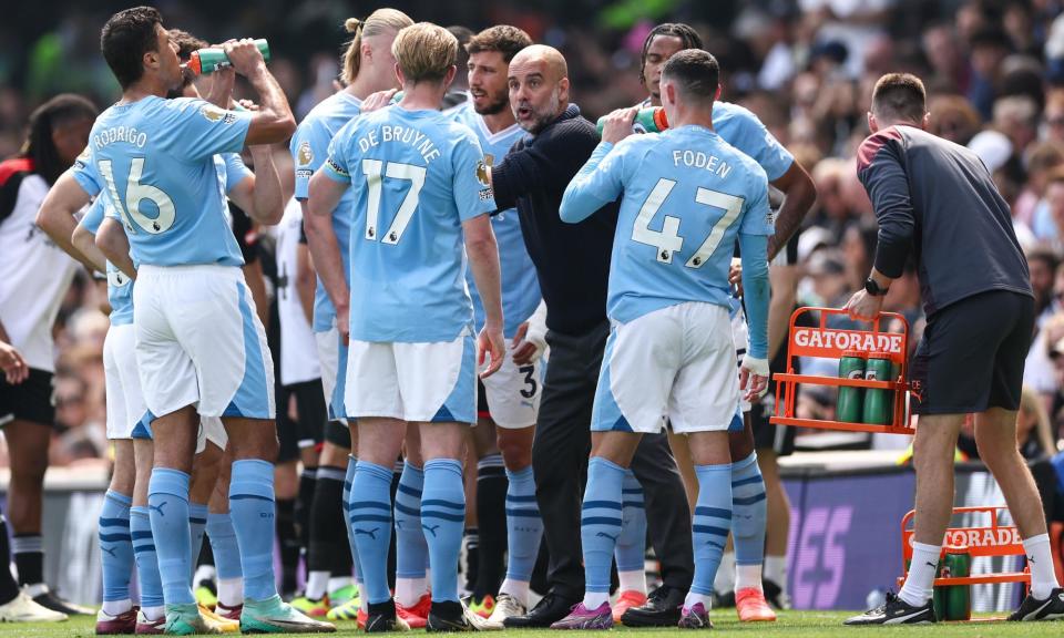 <span>Pep Guardiola talks to his squad during <a class="link " href="https://sports.yahoo.com/soccer/teams/man-city/" data-i13n="sec:content-canvas;subsec:anchor_text;elm:context_link" data-ylk="slk:Manchester City;sec:content-canvas;subsec:anchor_text;elm:context_link;itc:0">Manchester City</a>’s win over Fulham.</span><span>Photograph: Jacques Feeney/Offside/Getty Images</span>