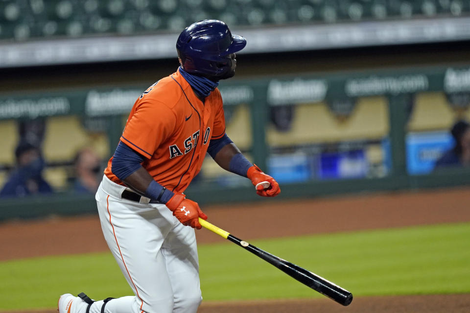 Houston Astros' Yordan Alvarez watches his three-run home run against the Seattle Mariners during the first inning of a baseball game Friday, Aug. 14, 2020, in Houston. (AP Photo/David J. Phillip)