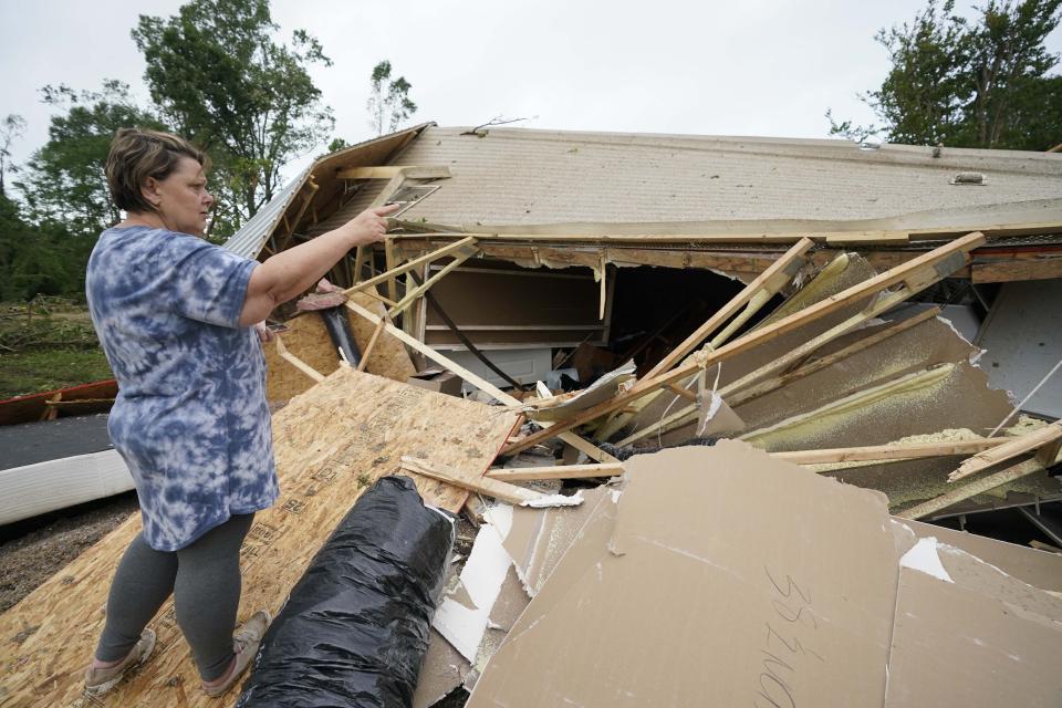 Vickie Savell gestures whole looking at the remains of her new mobile home early Monday, May 3, 2021, in Yazoo County, Miss. Multiple tornadoes were reported across Mississippi on Sunday, causing some damage but no immediate word of injuries. (AP Photo/Rogelio V. Solis)