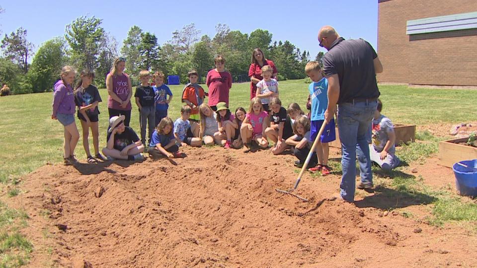 Potato farmer Ben Visser gave students a lesson in how to plant potatoes in the community garden at Vernon River Consolidated School. 