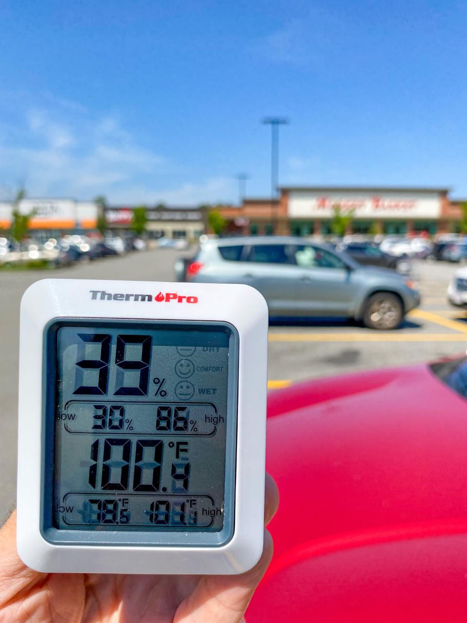 The air temperature reads 100.4 degrees in the parking lot at South Coast Marketplace in Fall River.