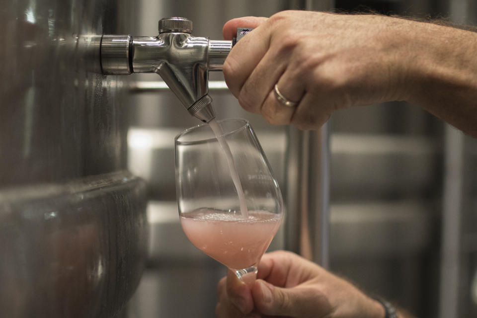 A winemaker pours rosé at the Chateau Sainte Roseline in the southern France region of Provence, Friday Oct. 11, 2019. European producers of premium specialty agricultural products like French wine, are facing a U.S. tariff hike on Friday, with dollars 7.5 billion duties on a range of European goods approved by the World Trade Organization for illegal EU subsidies to aviation giant Airbus.(AP Photo/Daniel Cole)