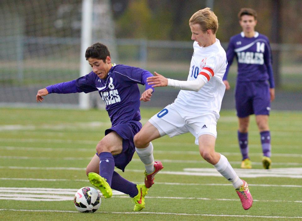 St. Cloud Apollo's Leighton Lommel (10) works to steal the ball from Rochester Lourdes' Esteban Bedoya (8) during the first half.