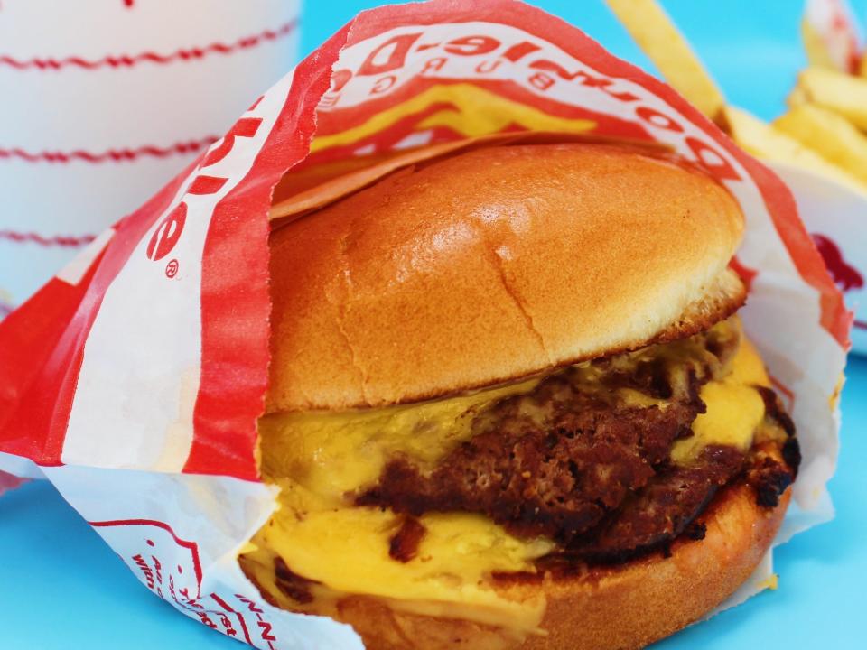 in n out double double, fries, and drink on blue background