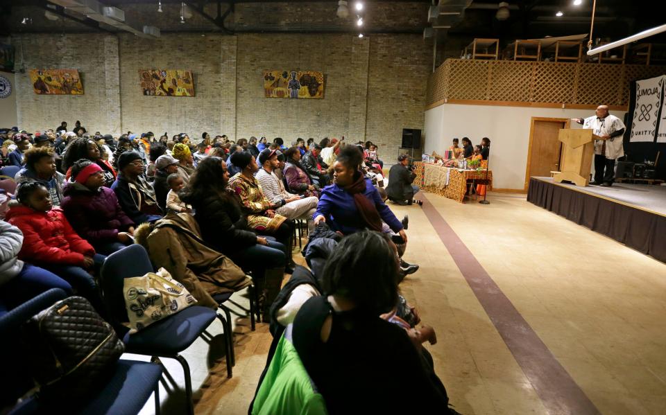 Clayborn Benson, founder of the Wisconsin Black Historical Society, reminds the crowd of the seven principles of Kwanzaa during opening ceremonies Dec. 26, 2017. The celebration of Kwanzaa is about embracing principles of unity, self-determination, collective work and responsibility, cooperative economics, purpose, creativity and faith.