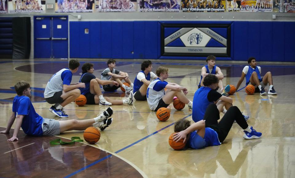 Valley Christian players listen to head coach Greg Haagsma during a practice at Valley Christian High School in Chandler on Jan. 23, 2024.