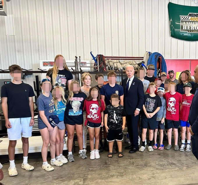 President Bden poses for a picture with several kids wearing Donald Trump gear during his visit to Shanksville, Pa., on Sept. 11, 2024. X / Jana Musser