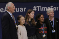Climate activists Greta Thunberg, 2nd left, and Luisa Neubauer, center, pose with leading climate scientists at the COP25 summit in Madrid, Spain, Tuesday, Dec. 10, 2019. Thunberg is in Madrid where a global U.N.-sponsored climate change conference is taking place. (AP Photo/Paul White)