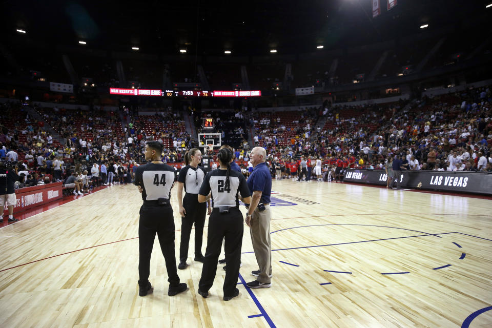 Officials confer after an NBA summer league basketball game between the New York Knicks and the New Orleans Pelicans was stopped following an earthquake Friday, July 5, 2019, in Las Vegas. (AP Photo/Steve Marcus)