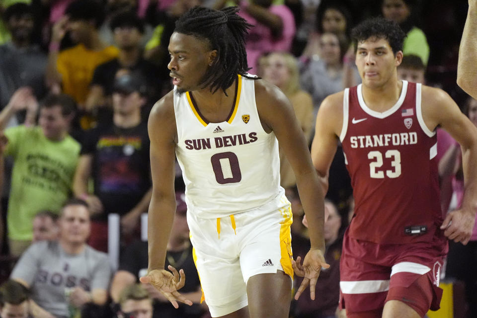 Arizona State guard Kamari Lands (0) celebrates his made 3-pointer as Stanford Cardinal forward Brandon Angel (23) looks on during the first half of an NCAA college basketball game Thursday, Feb. 1, 2024, in Tempe, Ariz. (AP Photo/Ross D. Franklin)
