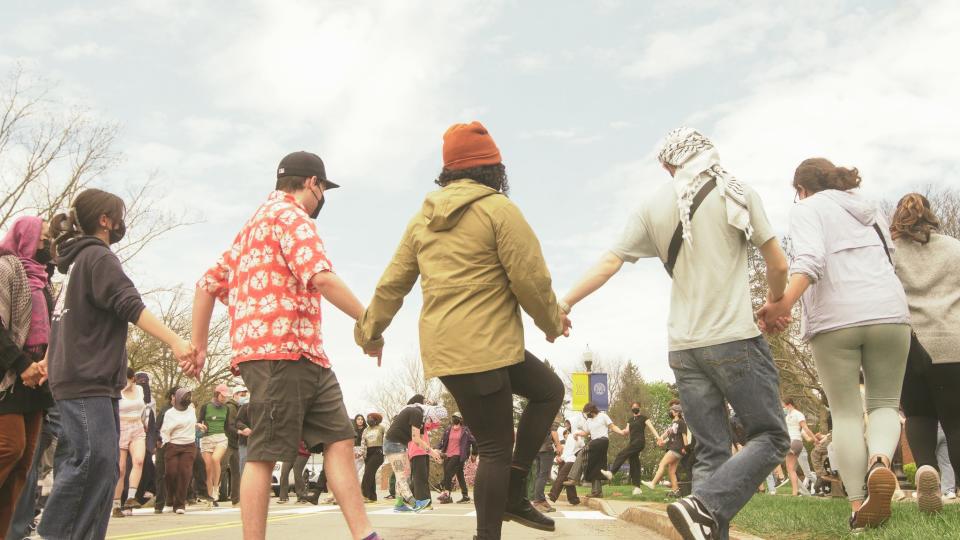 Outside Wallis Hall on the University of Rochester's River Campus, students maintain their high energy, expressing their protest through the native dance Debkeh.