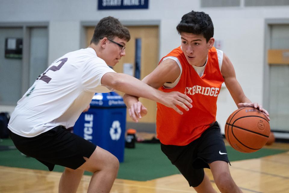 Uxbridge's Michael Stark drives while Leicester's Brody Grant defends during Auburn Summer League play on Monday at Auburn High. Uxbridge won the game, 42-34.