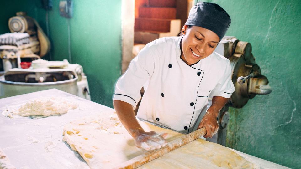 Baker kneading pastry dough.