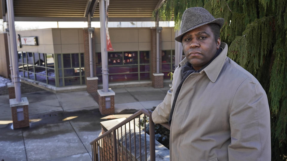 Andre Brady poses for a photo outside the former public university bookstore, Thursday, Jan. 21, 2021, in Youngstown, Ohio. On its surface, the story of Brady's fight to keep his well-paying union job at a public university bookstore that was privatized isn't unique. Hundreds of workers have watched as their positions at once-independent college bookstores disappeared in recent years as operations were transferred to national book retailing giants. What makes the Ohio man's case notable is that it created a five-year paper trail that provides rare detail on the handover of the store from Youngstown State University to Barnes & Noble. (AP Photo/Tony Dejak)