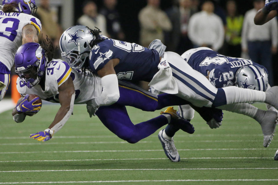 Minnesota Vikings running back Dalvin Cook (33) is tackled by Dallas Cowboys middle linebacker Jaylon Smith (54) in the second half of an NFL football game in Arlington, Texas, Sunday, Nov. 10, 2019. (AP Photo/Michael Ainsworth)