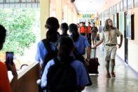 Teeraphong Meesat, 29, known as teacher Bally walks to classroom prior to the start of his English class at the Prasartratprachakit School in Ratchaburi Province