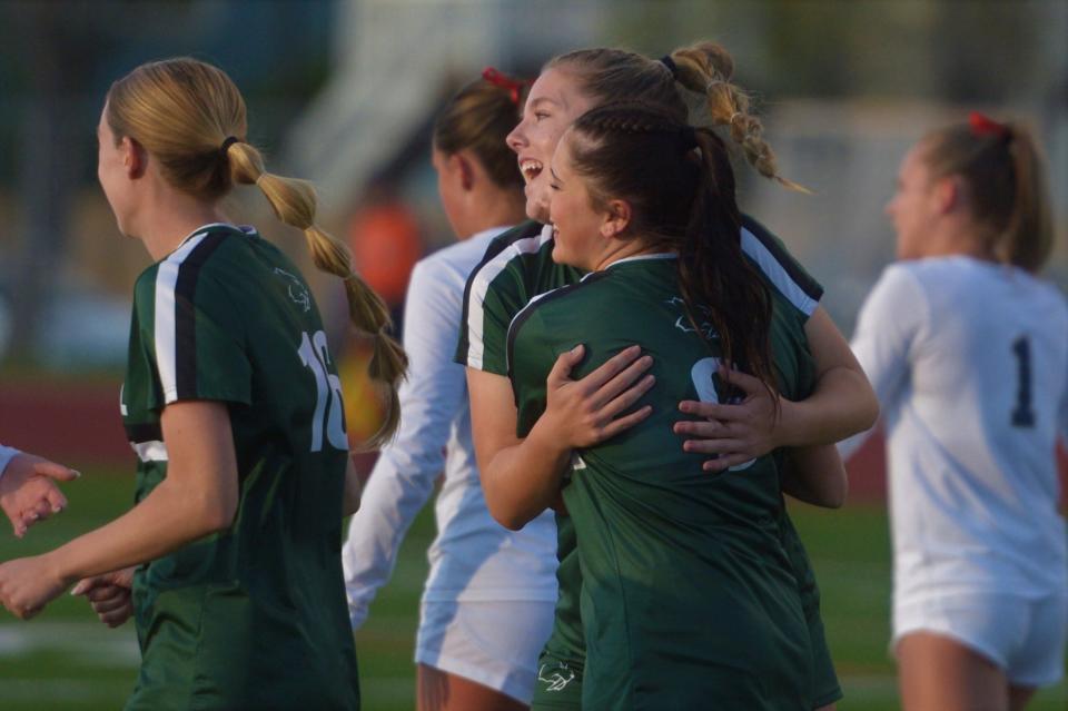 Fossil Ridge soccer players hug Anna Rogers (right) after she scored during a Class 5A second-round playoff game against Chaparral on Friday, May 10, 2024.