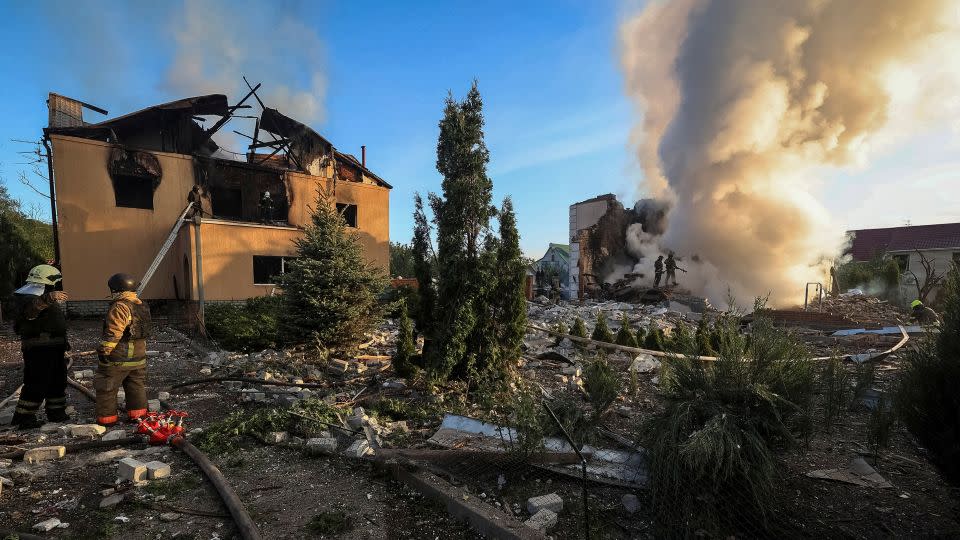 Firefighters at the site of a Russian missile strike in Kharkiv, Ukraine, on May 10, 2024. - Vyacheslav Madiyevskyy/Reuters