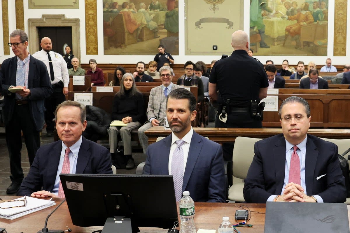 Donald Trump Jr sits with attorneys Christopher Kise, left, and Clifford Robert, right, on Monday (REUTERS)