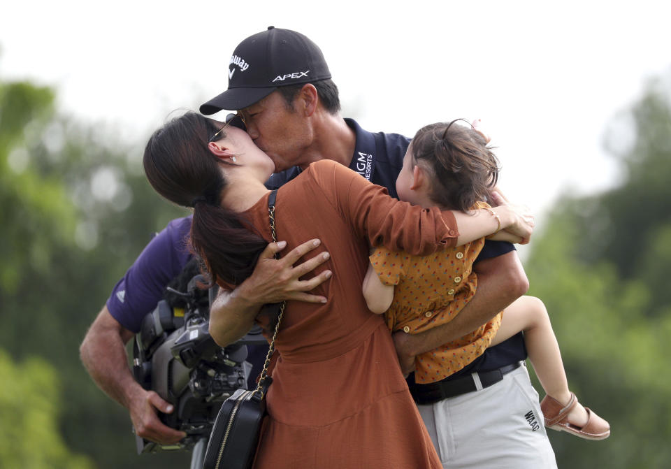 Kevin Na, center, kisses his wife Jullianne as he holds daughter Sophia after winning the Charles Schwab Challenge golf tournament Sunday, May 26, 2019, in Fort Worth, Texas. (AP Photo/ Richard W. Rodriguez)