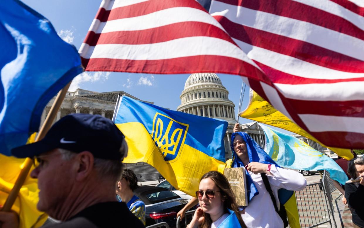 Supporters of Ukraine waved US and Ukrainian flags outside the Capitol after the aid package was approved