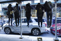 News photographers stand on scaffolding to get a photo of Manhattan District Attorney Alvin Bragg as he leaves his office, Thursday, March 30, 2023, in New York. (AP Photo/Mary Altaffer)