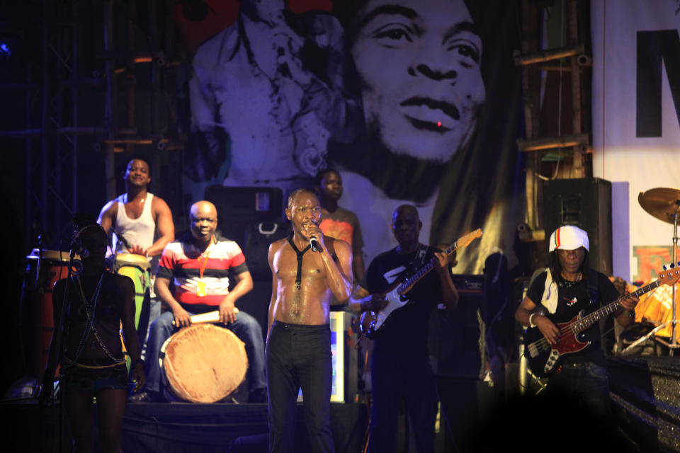 FILE- Seun Kuti, son of Afrobeat music legend Fela Kuti, centre, performs at "Felabration," an annual event paying homage to his father, at the New Afrika Shrine in Lagos, Nigeria in the early hours of Oct. 20, 2013. A Nigerian Afrobeat star was arrested after being accused of assaulting a police officer in the commercial hub of Lagos. Seun Kuti was detained at the Lagos State police headquarters after turning himself in on Monday, May 15, 2023. (AP Photo/Sunday Alamba, File)