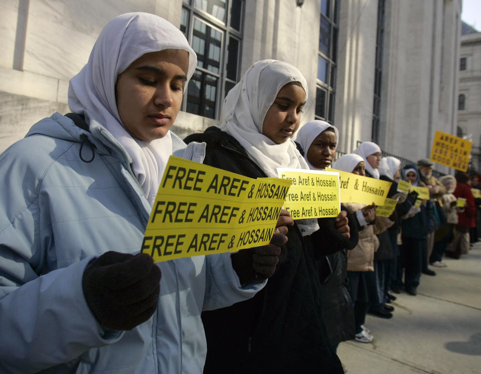 FILE - Aleena Hussain, left, Sarah Mohamed Ali, center, and Ubaidah Abdul-Rahman, hold signs outside the federal courthouse, Thursday, March 8, 2007, in Albany, N.Y. The girls, students at AnNur Islamic School in Schenectady, N.Y., stood outside the courthouse in support of Yassin Aref and Mohammed Hossain, who were each sentenced to 15 years in federal prison for their roles in a money laundering scheme that involved a fictional terror plot. (AP Photo/Mike Groll, FILE)