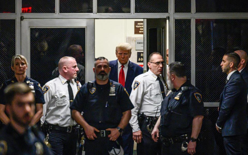 Mr Trump was solemn as he arrives at the courtroom - ED JONES