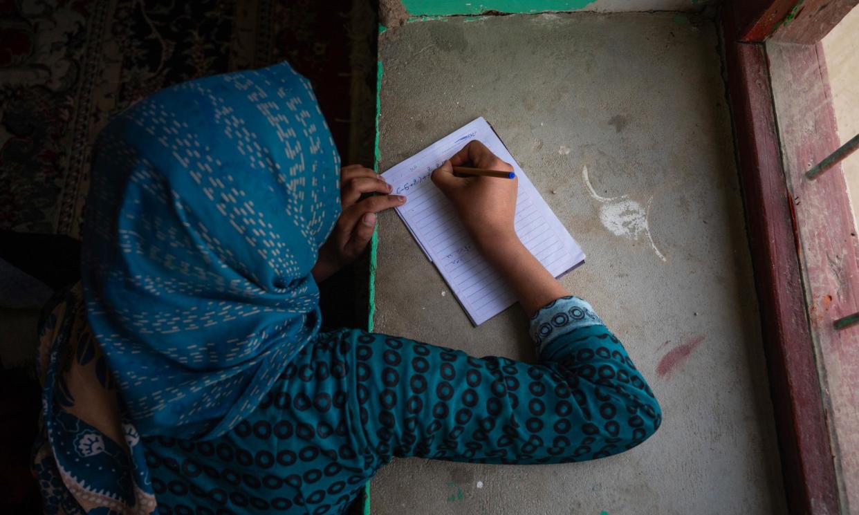 <span>A girl studies in secret in Afghanistan, after the Taliban closed girls’ secondary schools. The cost of gender inequality ‘is just way too high,’ says UN Women’s Papa Seck. </span><span>Photograph: The Guardian</span>